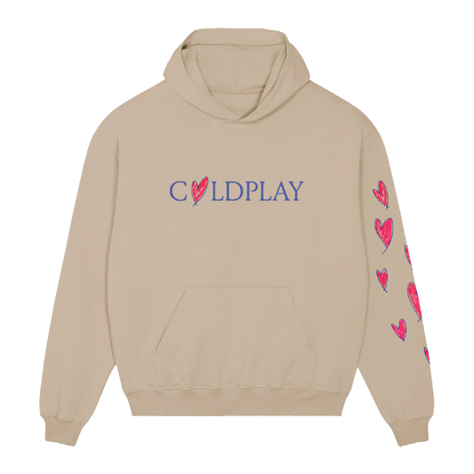 Front: Light beige hoodie. COLDPLAY is printed across the chest in purple, with a hand-drawn heart making the letter O; The heart’s outline is purple, filled in with pink fuchsia. Chris’s hand-drawn hearts run vertically down the left sleeve. All hearts are pink fuchsia, but outlined in purple. They’re different sizes, some thicker, some thinner, some slightly tilted, creating a playful pattern. The hoodie has a large front pocket.
