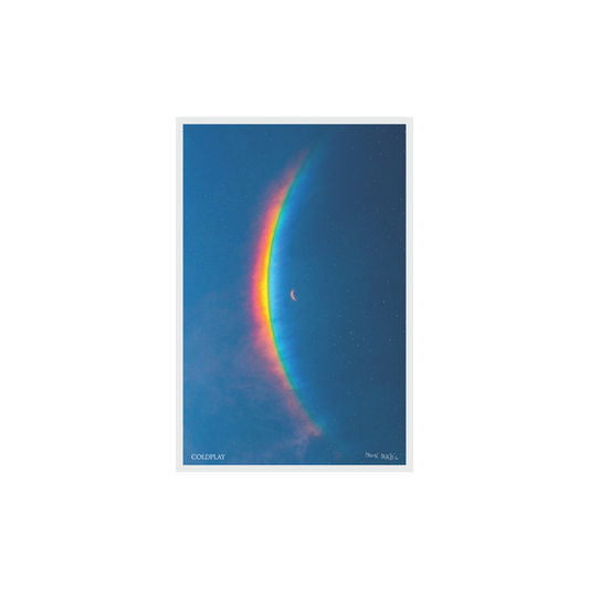 Moon Music Lithograph: Album artwork features a crescent moon to the right of a large, arced rainbow light dispersion in a blue starry sky. The dispersion colors flow from red to orange, yellow, green, light and dark blue. COLDPLAY is printed in white serif-style text in the bottom left corner. With Moon Music in the bottom right corner in Chris’s handwriting.