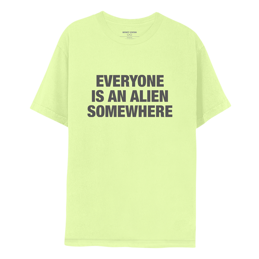 Front: This is Guy’s shirt. It’s a bright, yellowish lime green. EVERYONE IS AN ALIEN SOMEWHERE is printed in dark grey. The text is large and bold, in 3 lines: EVERYONE, IS AN ALIEN, SOMEWHERE.